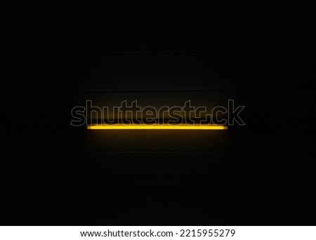 Yellow neon light from the lamp in a dark room light bulb in a dark room fluorescent LED Laser neon light stick effect Fluorescent light in the dark Suitable for background images and abstract 