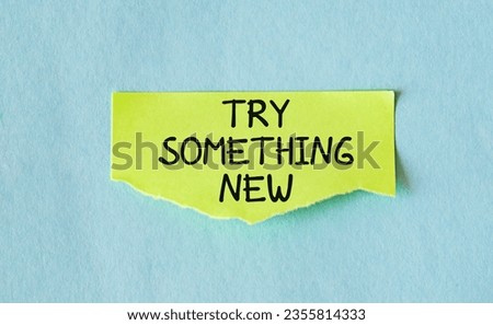 Yellow note on blue background with text TRY SOMETHING NEW, to encourage people who are tired of feeling stuck in job or career, to have awareness, inspiration and action around new pathways