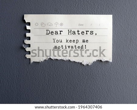 Yellow Note on grey wall with text THANK YOU HATERS , FOR BEING MY MOTIVATORS - Self reminder to stop let haters affect or take advantage of the situation but use them as fuel for success instead