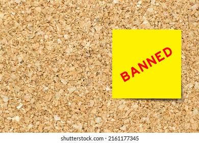 Yellow note paper with word banned on cork board background with copy space - Shutterstock ID 2161177345