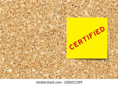 Yellow Note Paper With Word Certified On Cork Board Background With Copy Space