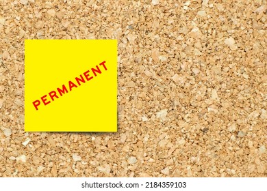 Yellow note paper with word permanent on cork board background with copy space - Shutterstock ID 2184359103