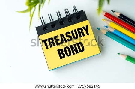 Yellow Notepad with Treasury Bond Text on White Desk with Colored Pencils for Financial Planning, Government Debt, and Fixed Income Security Themes.