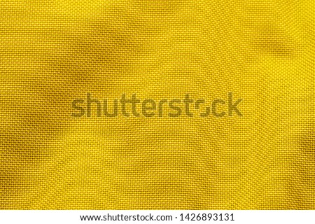 Yellow Nylon Fabric Texture Background. Thick Fabric for Backpacks and Sports Equipment