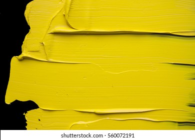 Yellow oil paint on a black background