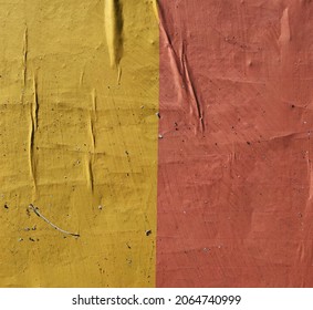 Yellow and orange crinkled dirty stained weathered poster surface
