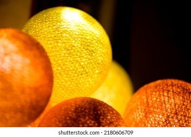 Yellow orange glowing balls. Orange glowing balls. Yellow glowing balls. Glowing balls on garland