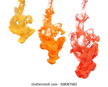 Yellow and Orange Ink dropped into water isolated on white