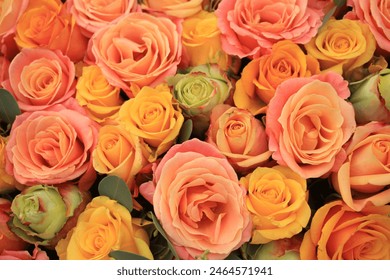 Yellow, orange and pink roses in a floral arrangement at a wedding - Powered by Shutterstock