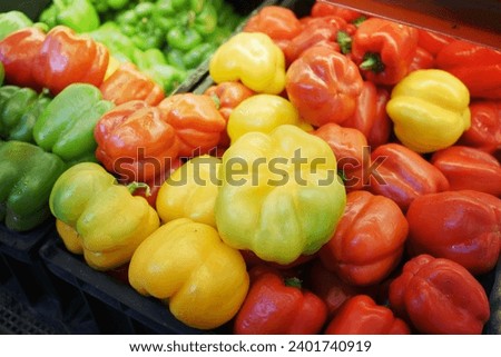 Yellow orange and red capsicum on display for sale ,