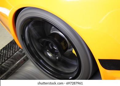 Yellow Orange Sports Car On A Dyno Performance Tuning Track Close Up