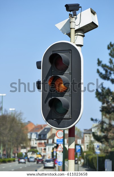 Yellow - Orange traffic light in the city of\
brussels, Europe