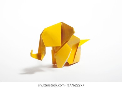 Yellow origami elephant  isolated on white background