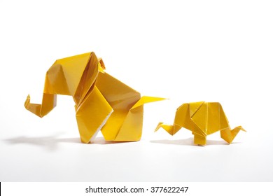 Yellow origami elephants family isolated on white background 