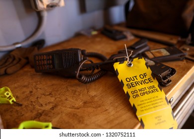 Yellow Out Of Service Tag Attached On Defect Broken Two Way Radio On The Table Do Not Use Or Operation Construction Mine Site Perth, Australia