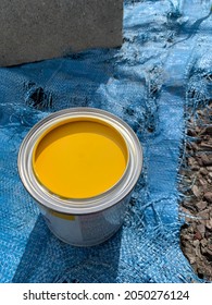 Yellow Paint In Can On Old Blue Tarp