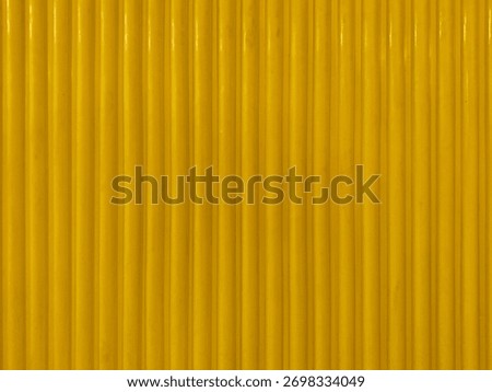 Yellow paint fluted panel or fluted strips, with round edge, seamless background texture.