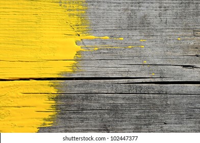 yellow paint on old wooden background