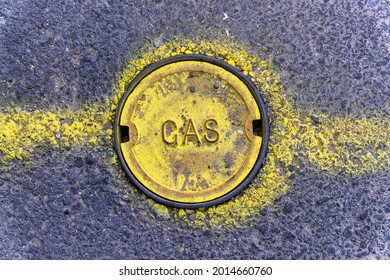 A Yellow Painted Gas Manhole On The Street