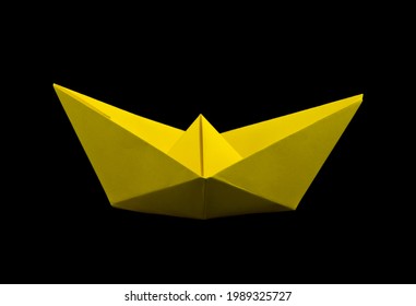 Yellow Paper Boat Isolated On A Black Background. Detail For Design. Design Elements. Macro. Food. Background For Business Cards, Postcards And Posters. 