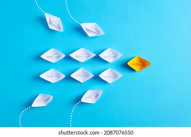 Yellow Paper Boat Leads White Paper Ships With New Ones Joining The Team. Teamwork, Collaboration, Cooperation, Leadership, Partnership And Participation Concept.