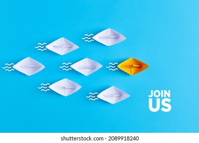 Yellow paper boat leads white paper ships. Join us, job vacancy or community membership announcement concept. 