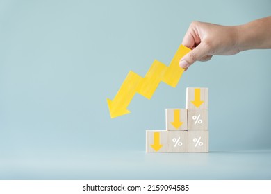 Yellow Paper Cut Arrow Going Down Negative Trend On Wooden Blocks With Percentages. Concept Of Profit Decreasing In Percentage.