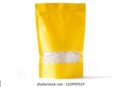 Yellow Paper Doypack Stand Up Bio Pouch With Window  Zipper On White Background Filled With Rice