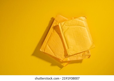 Yellow Paper Envelope, Postal Parcel. Kraft Bag Mailers Padded Shipping. Mailing Courier Envelopes Packaging Bags. Empty Copy Space For Mockup.