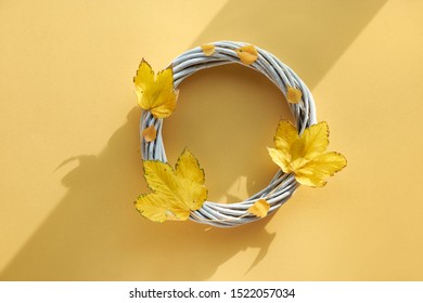 Yellow Paper Flat Lay With Decorative Wattle Wreath Decorated With Natural Yellow Autumn Maple Leaves