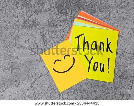 Yellow paper notes spelling Thank You with smiling face. Handwritting on sticky notes. Gratitude. Positive attitude concept