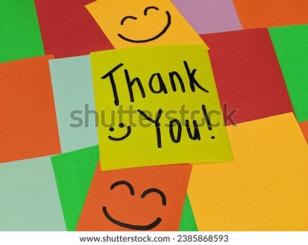 Yellow paper notes spelling Thank You with smiling face. Handwritting on sticky notes. Gratitude. Positive attitude concept