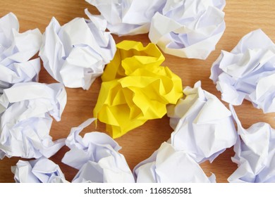 Yellow paper with white paper crumpled on wood background,Inspiration concept.