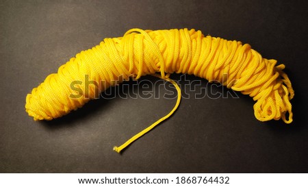 Yellow paracord closeup in black background Stok fotoğraf © 