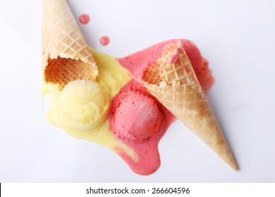 yellow passion fruit and red strawberry ice cream dropped melt on white background