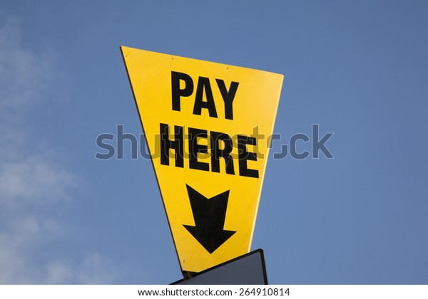 Yellow Pay Here Sign in Car\
Park
