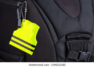 Yellow Pedestrian Safety Reflector On A Black Backpack, Closeup View. Concept Of Safety