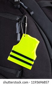 Yellow Pedestrian Safety Reflector On A Black Backpack, Closeup View. Concept Of Safety