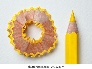 yellow pencil and shavings on white paper background - Powered by Shutterstock