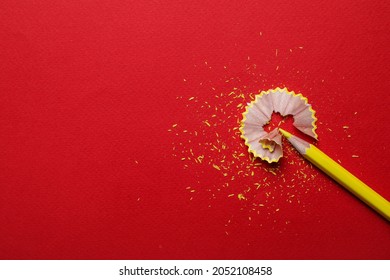 Yellow pencil and wooden shaving on red background, flat lay. Space for text - Powered by Shutterstock