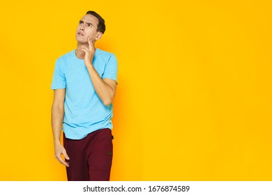 Yellow peony blue tank top red pants handsome guy - Powered by Shutterstock