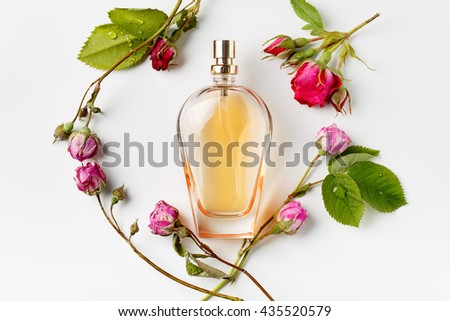 yellow perfume bottle surrounded by flowers