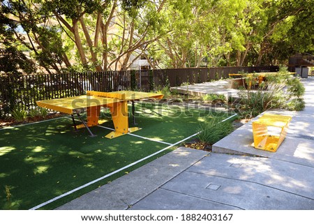 Yellow ping pong table under the shade