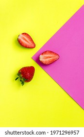 Yellow and pink strawberries form a triangle on the yellow and the strawberries placed around the vertex remaining in the center of the image. Healthy fruit concept - Shutterstock ID 1971296957