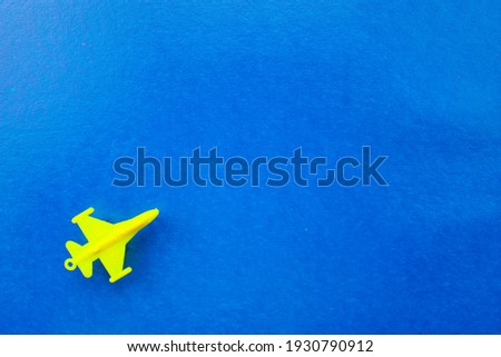 Yellow plane on a blue background. The concept of transportation, airmail, airlines.
