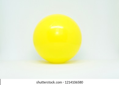 Yellow plastic ball isolated on white background