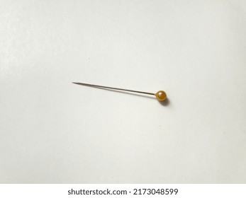 A Yellow Plastic Head Sewing Pin Or Straight Pin