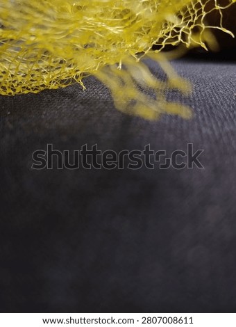 Yellow plastic poly net mesh bag.