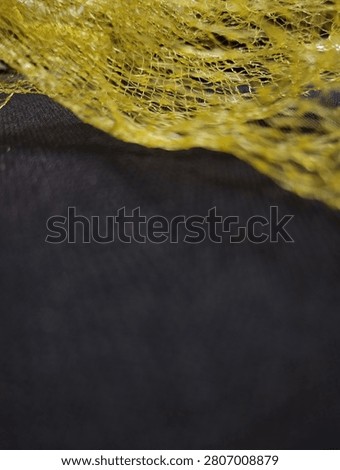 Yellow plastic poly net mesh bag.