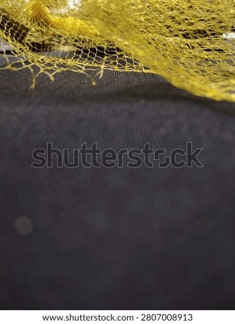 Yellow plastic poly net mesh bag.